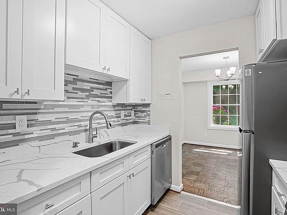 Brand new kitchen with quartz counters, new sink, new faucet, new dishwasher, new fridge, new stove, and new microwave above the stove.