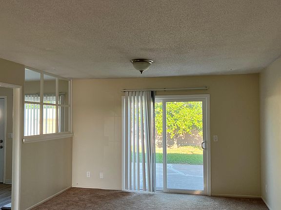 View to backyard from living room. Kitchen on left.