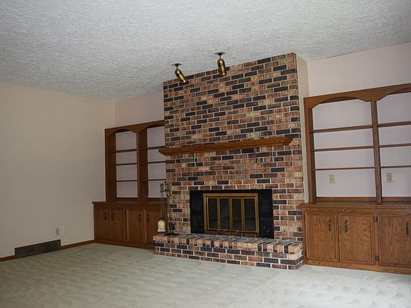Large Family Room with Fireplace and Built in Shelving