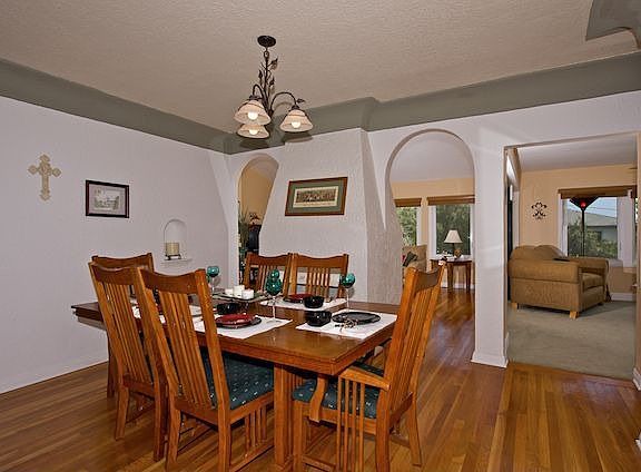 Cozy Formal Dining Room w/Fireplace & Hardwood Flooring