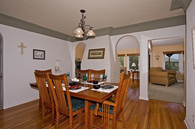 Cozy Formal Dining Room w/Fireplace & Hardwood Flooring