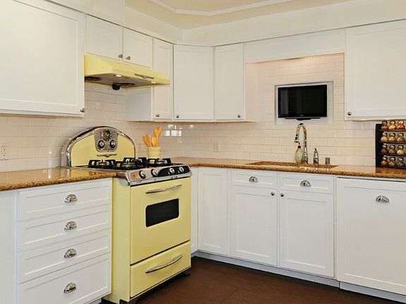 Wonderful kitchen with under cabinet lighting, Marmoleum floors, Caesarstone quartz counters & modern 'retro' appliances.