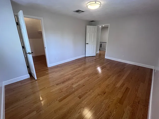 Primary bedroom with closet & overhead light