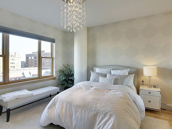 Luxurious master bedroom with upgraded, elegant wall coverings, lighting and cool mirrored barn door closing off private master walk in closet and spa like bath. Nice sized and windows.