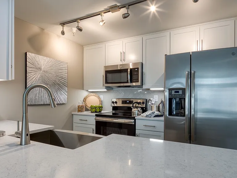 Enjoy the art of cooking with your sleek appliances and farmhouse style sink.