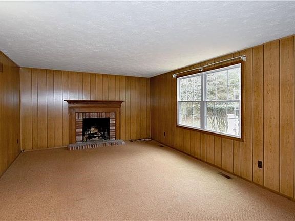 Relax in the family room with a fireplace as the focal point of this comforting room.