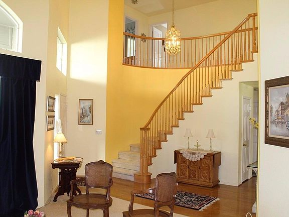 As you enter, the Living Room greets you as well as a grand, spiraling staircase.
