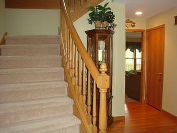 Foyer and view of one of the two stairways to the upper level.