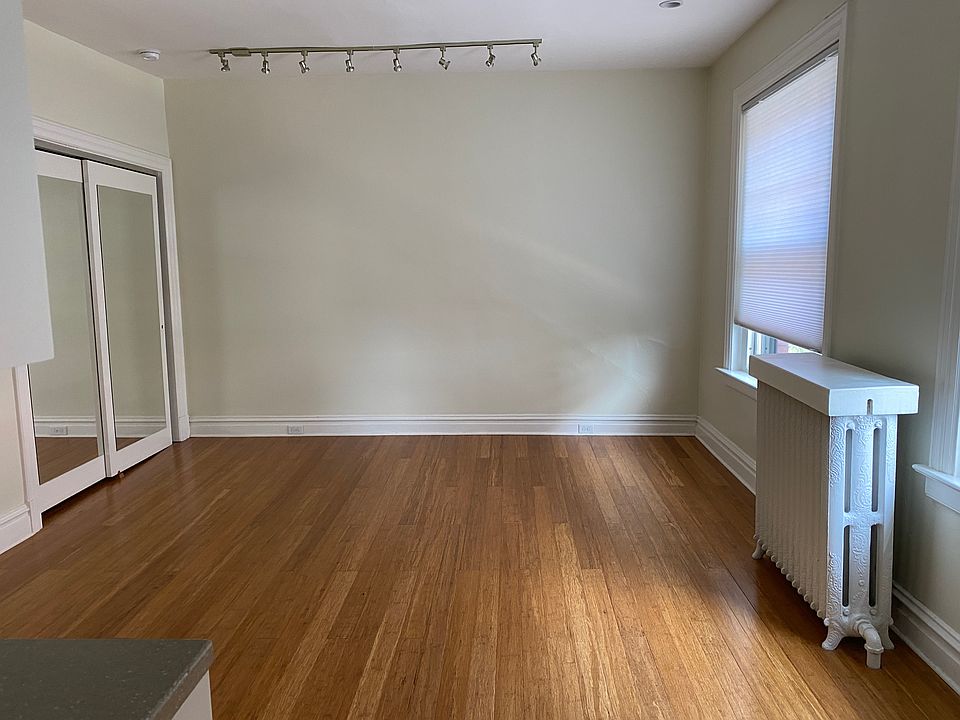 Adjacent to kitchen is the area for living/dining. Has 2 LARGE windows with pull down honeycomb shades