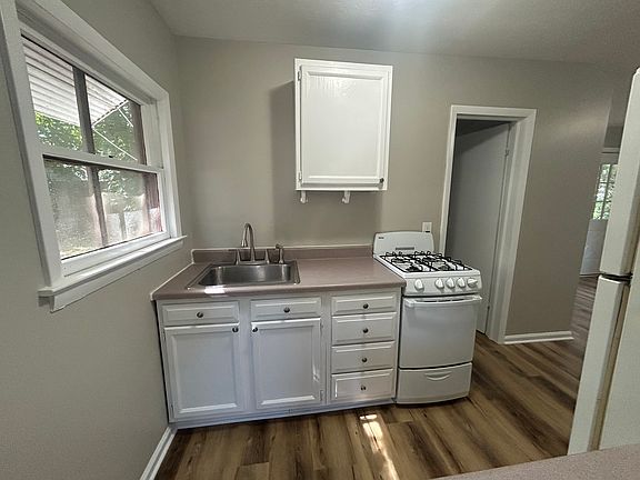 Kitchen area with connected gas range/stove and new cabinetry.