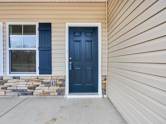 Entrance to property with stone siding