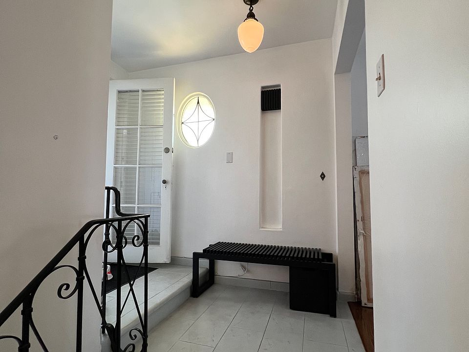 From top of stairway. Door to left is to balcony and opening at right is to living room.