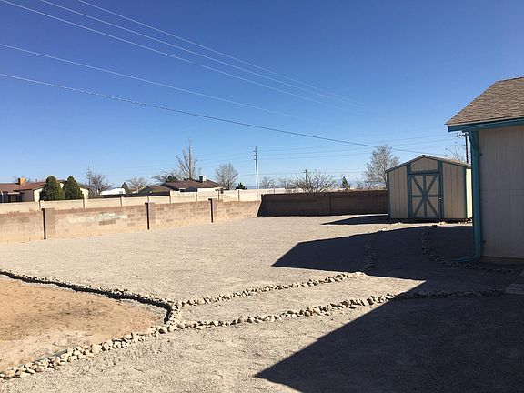 Huge, low maintenance back yard with large storage shed.
