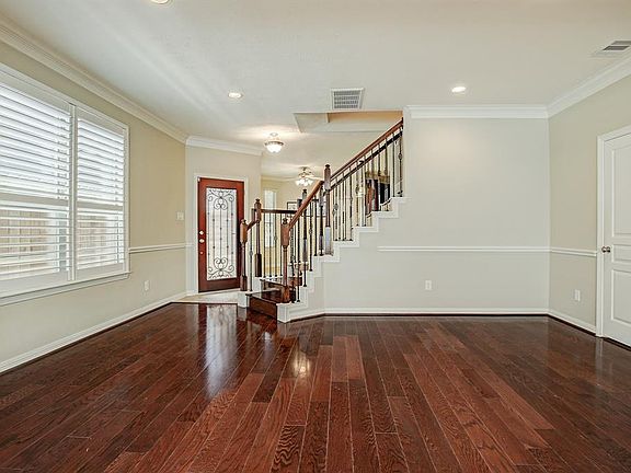 Step into this stunning space and know you are home. Dining room features gleaming hardwood floors, chair rail, decorative crown and base molding. You can also catch a glimpse of the entry with designer light and tile