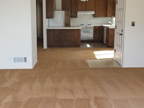 View from balcony into living room/dining/kitchen.