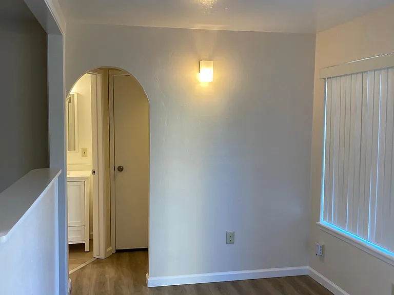 Transition from living room to bathroom and closet area.