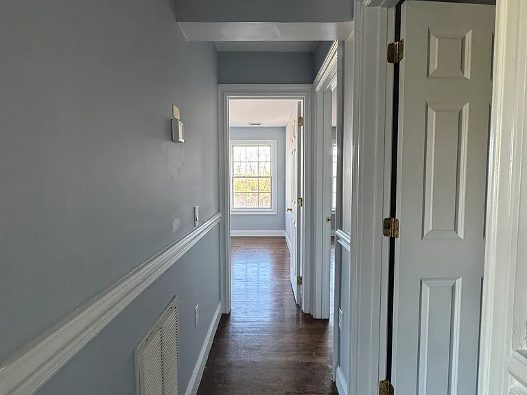 Hallway leading to bathroom and 2 bedrooms