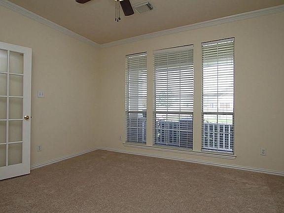 OFF THE GALLERY ENTRY HALL YOU'LL FIND THIS SPACIOUS PRIVATE STUDY WITH WINDOWS OVERLOOKING THE FRONT PORCH.