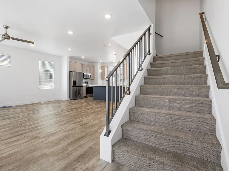 Living room ft stairs leading to third floor