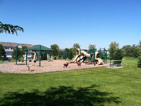 Park and play land next to pond.