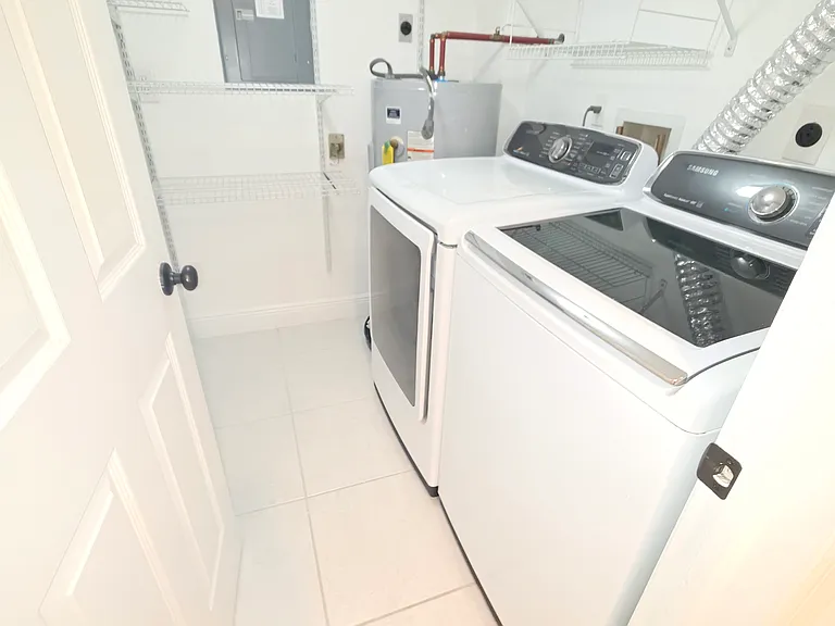 Laundry room with washer and dryer and storage.
