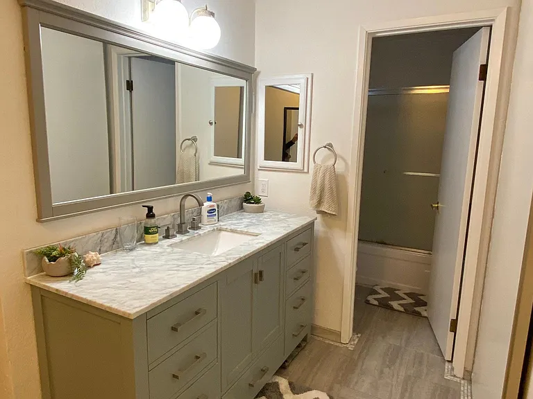 The bathroom has been completely remodeled with vanity cabinet, granite countertop, tile floor, matching mirror and medicine cabinet. Full-sized closet with built in shelves; and separate room with bath/shower and toilet.