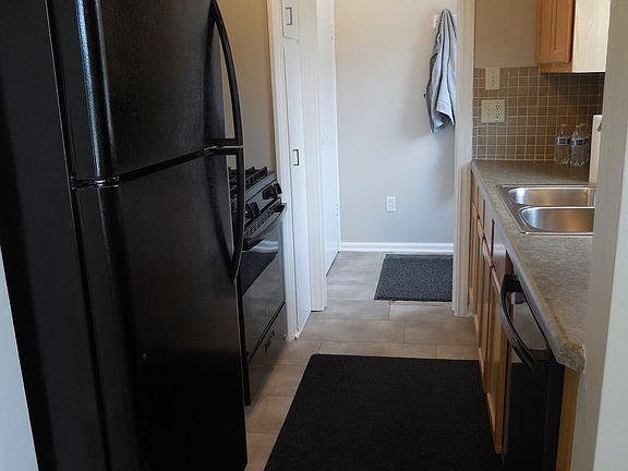 View of kitchen and side entry from dining area
