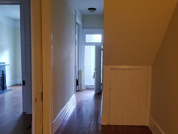 Entrance with long hall to what could be a desk area; on left is part of bedroom #2 with bedroom #1 in background