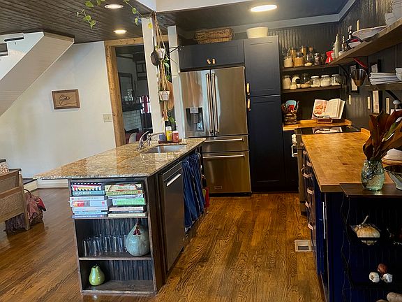 View of open shelf kitchen & loft from mudroom