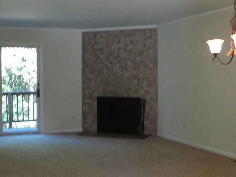 1st Floor-Living Room/Dining areas, with nook area (not in pic) Entrance to private deck, viewing wooded area and wildlife