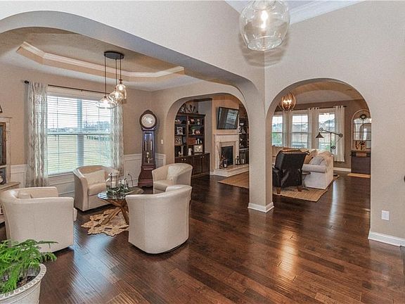 Main Level - Open concept floor plan features flex/formal dining room with custom tray ceiling. Archways open to Great Room and Gourmet Kitchen.