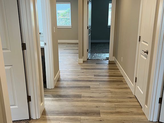 Front door entry with secondary bedrooms on either side of the hallway