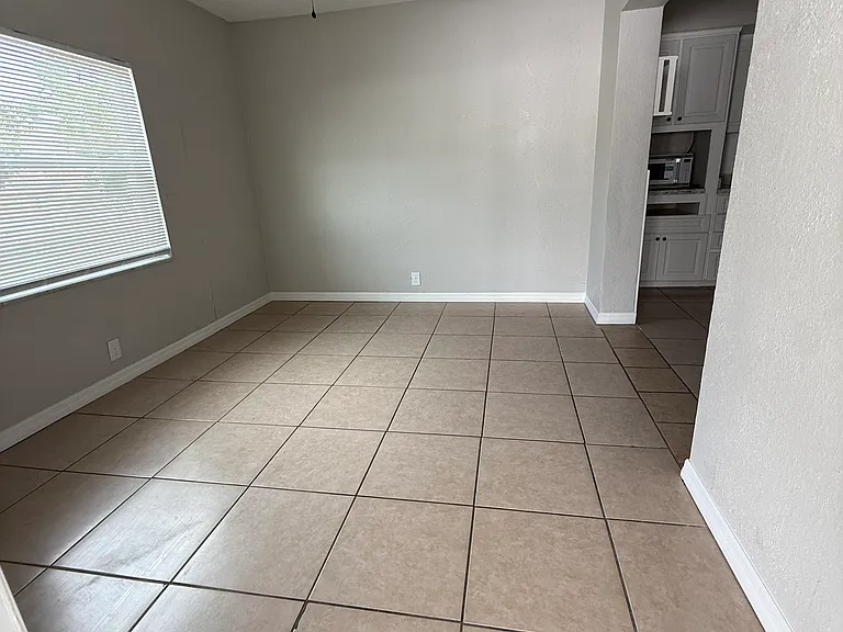Room off the kitchen that could be used for a study, or for a table, or an extra hang out room. Window is very large and looks out to the back yard