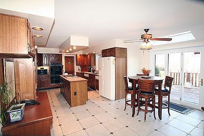 Sunny breakfast area in spacious kitchen with porcelain tile