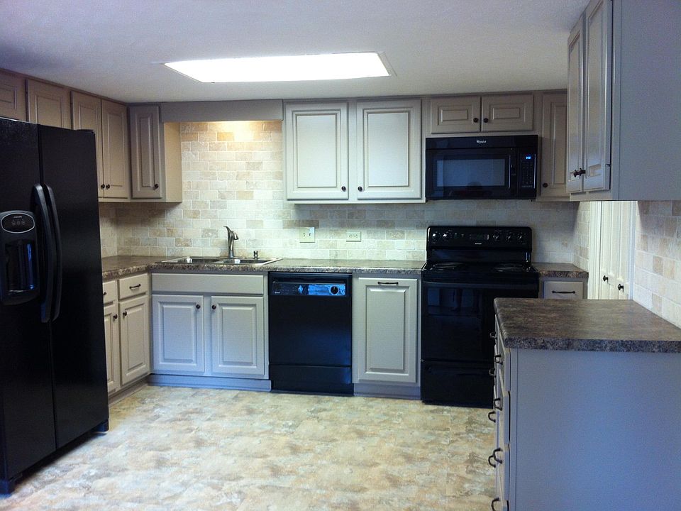 Renovated kitchen with new cabinet fronts, cabinet top and s