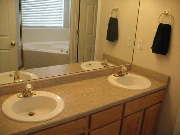 Master bath with his/her sinks, corner jetted tub and separate shower.