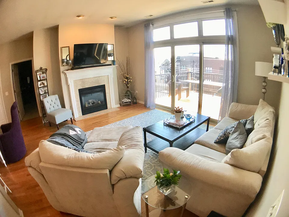 Living room, hardwood floor, fireplace, private balcony off of living room.
