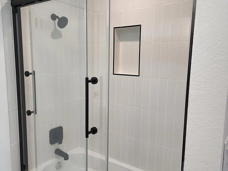Tiled full bath with modern matte black fixtures