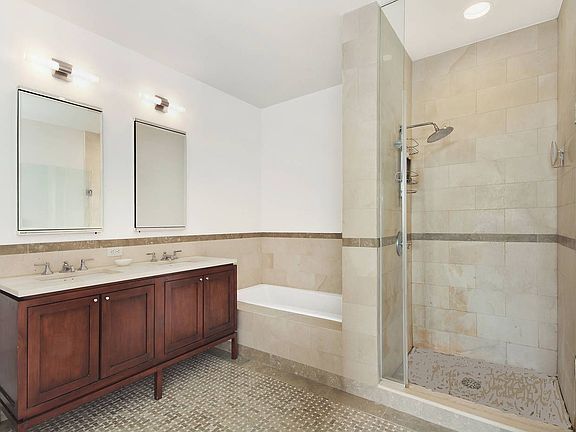 Large custom bath en suite with stall shower and soaking tub