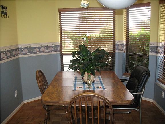 Breakfast nook that adjoins the kitchen area, has lots of windows that makes this room light and bright.