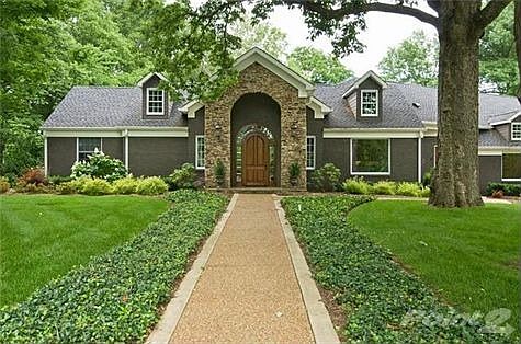 Inviting stone entry with custom front entry door