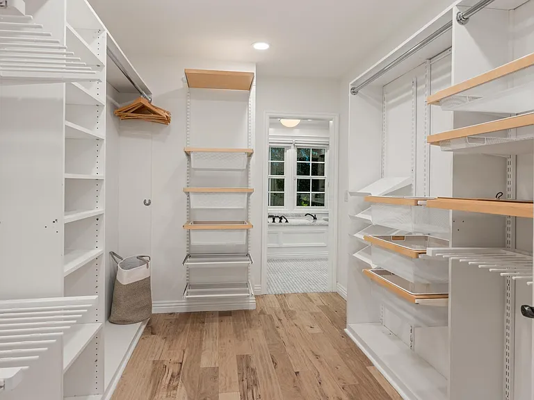 Step into a walk-in closet exuding chic elegance, providing a stylish haven for your wardrobe.