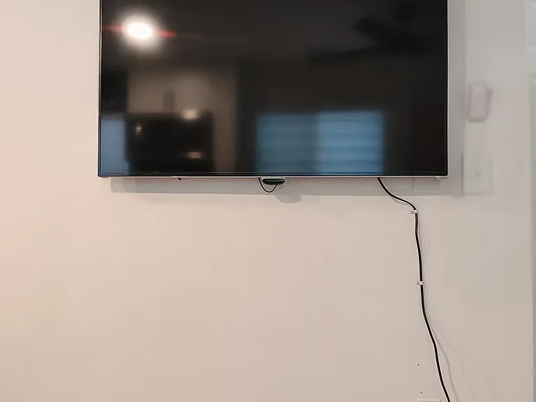 50 in tv with Roku in sitting area. Log into your favorite app. High speed wifi included