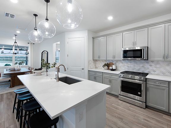 Gourmet kitchen with center island and stainless steel appliances
