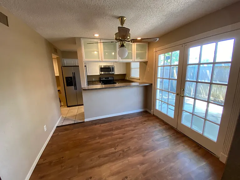 View from dinning room looking towards the kitchen. Patio doors on the right.