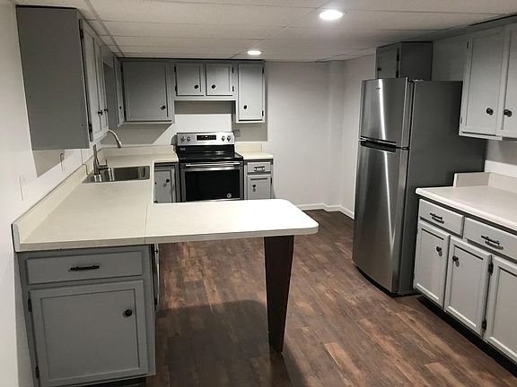 Large kitchen - new stainless appliances. Room for a table on opposite wall of photo
