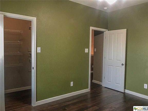 Third bedroom upstairs with walk-in closet.