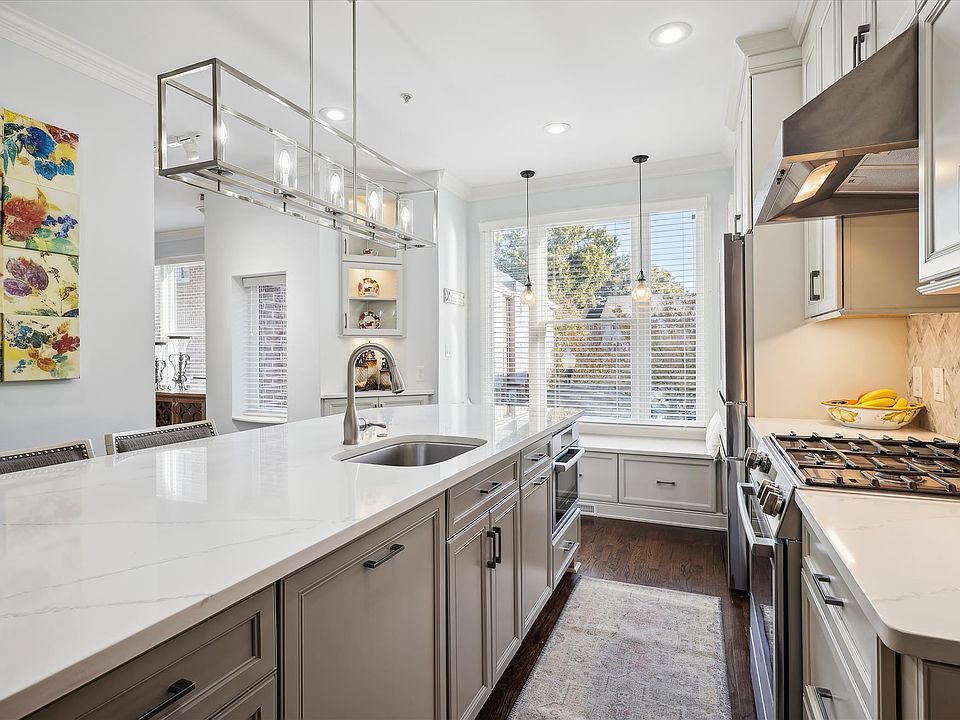 Kitchen boasts custom cabinets, quartz countertops and Bosc