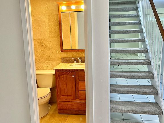 half bath to the left of stairs in the entrance. Remaining bathrooms and bedrooms are upstairs