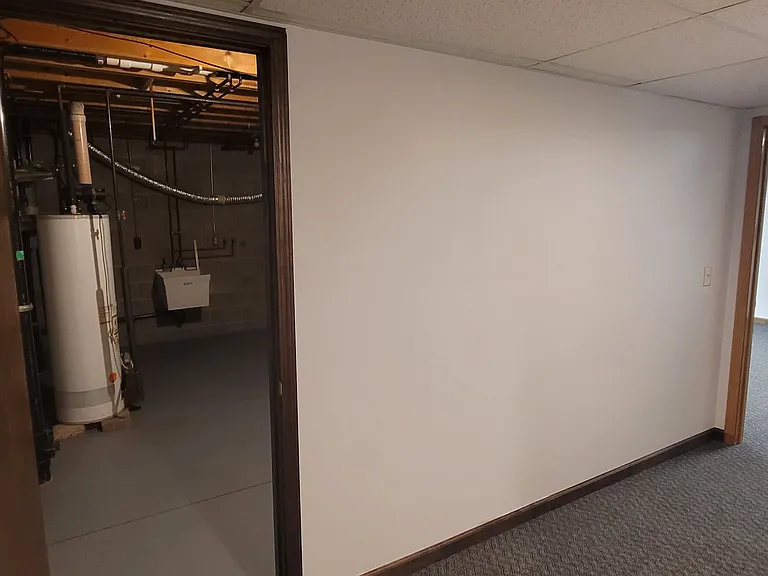 Walk-out basement view showing the third bedroom entrance and laundry room with washer/dryer hook-ups.